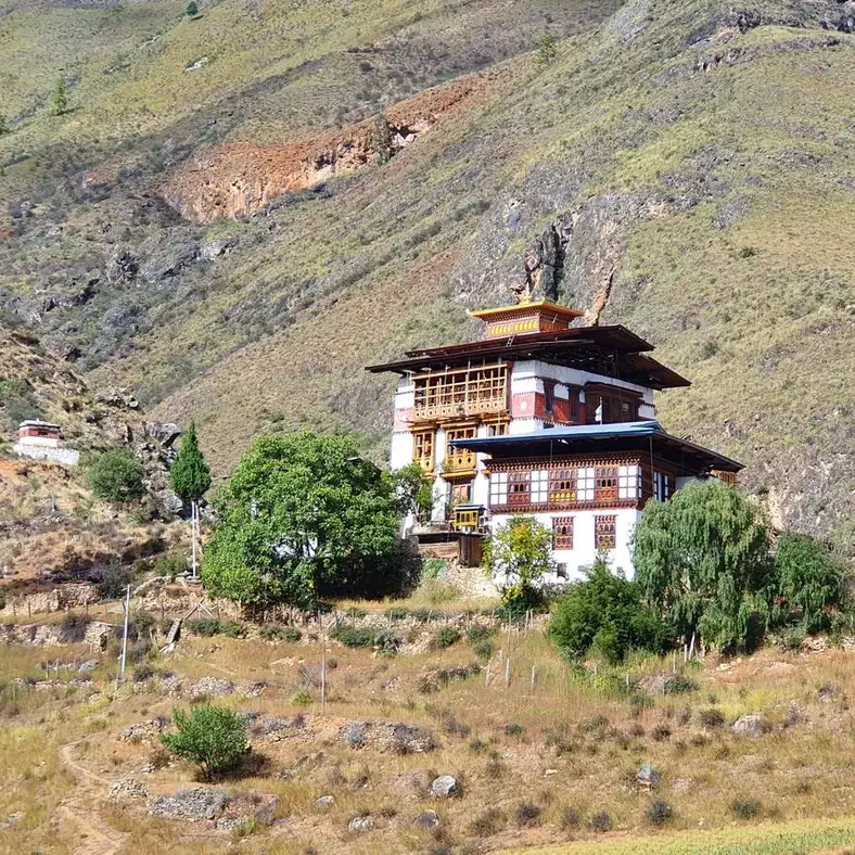 Dzong butanés entre montañas y campos en terrazas, valle de Paro